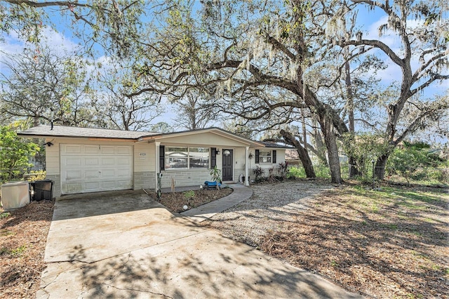 4928 Petunia Ct, New Port Richey, FL 34652 - view of front of house with an attached garage and concrete driveway
