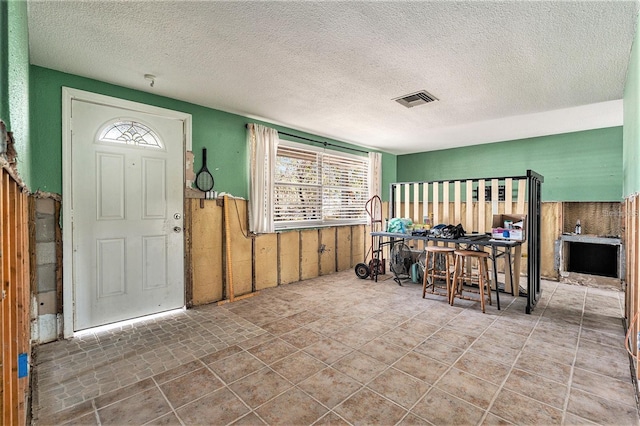 4928 Petunia Ct, New Port Richey, FL 34652 - foyer entrance featuring a textured ceiling, wainscoting, and wooden walls