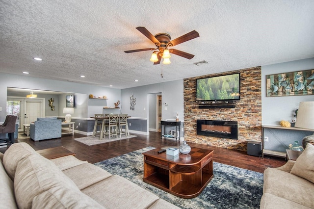 3173 Fountainhead Dr, Largo, FL 33770 - living area with a textured ceiling, wood finished floors, ceiling fan, recessed lighting, and a stone fireplace