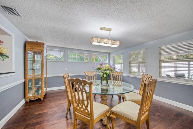 3173 Fountainhead Dr, Largo, FL 33770 - dining area with a textured ceiling and wood finished floors
