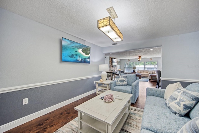 3173 Fountainhead Dr, Largo, FL 33770 - living area featuring wood finished floors, a textured ceiling, and a textured wall