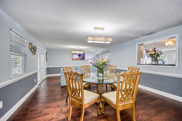 3173 Fountainhead Dr, Largo, FL 33770 - dining space with a textured ceiling and wood finished floors