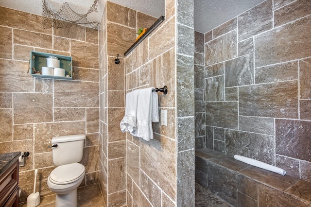 3173 Fountainhead Dr, Largo, FL 33770 - bathroom with tiled shower, vanity, and a textured ceiling