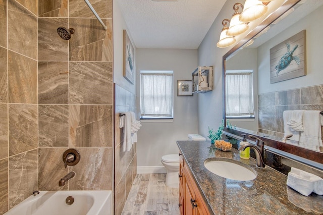 3173 Fountainhead Dr, Largo, FL 33770 - full bathroom with vanity, plenty of natural light, bathing tub / shower combination, a textured ceiling, and wood finished floors