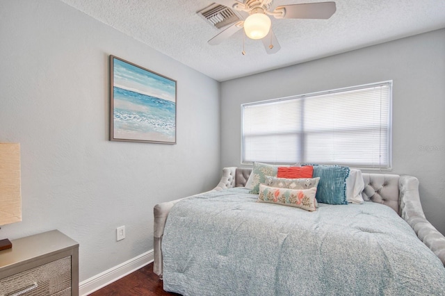 3173 Fountainhead Dr, Largo, FL 33770 - bedroom with dark wood-style floors, multiple windows, a textured ceiling, and ceiling fan