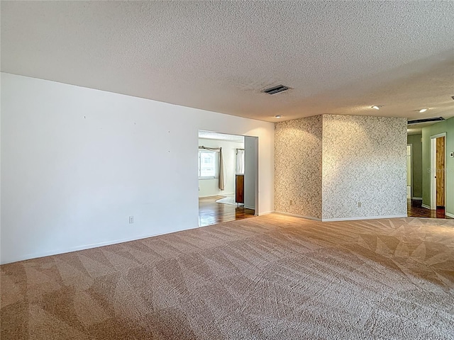 1607 New Bedford Dr, Sun City Center, FL 33573 - carpeted spare room featuring a textured ceiling and baseboards