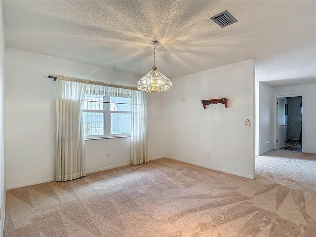 1607 New Bedford Dr, Sun City Center, FL 33573 - spare room with carpet flooring, a textured ceiling, and a chandelier