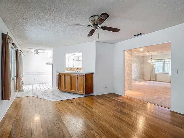 1607 New Bedford Dr, Sun City Center, FL 33573 - bar area with ceiling fan, light wood finished floors, and a textured ceiling