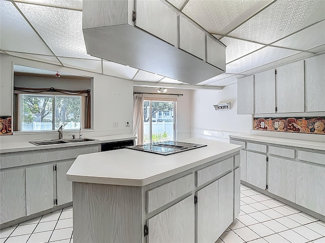 1607 New Bedford Dr, Sun City Center, FL 33573 - kitchen featuring black electric stovetop, light tile patterned flooring, and light countertops