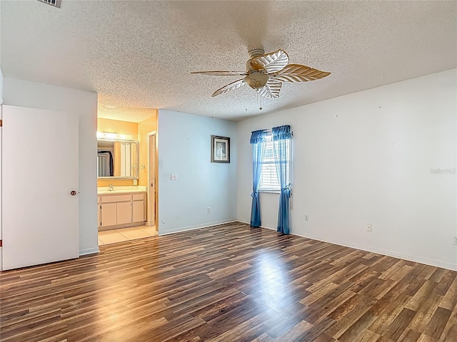 1607 New Bedford Dr, Sun City Center, FL 33573 - unfurnished room with ceiling fan, a textured ceiling, and wood finished floors