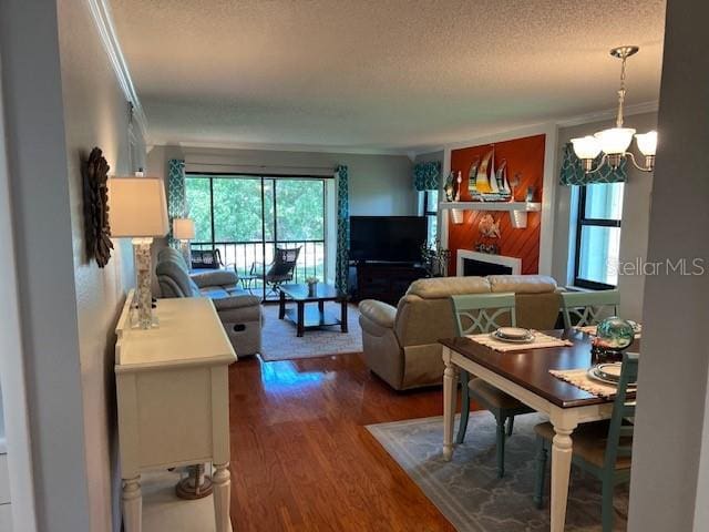140 Nina Way, Oldsmar, FL 34677 - living area with dark wood-type flooring, a textured ceiling, crown molding, a chandelier, and a fireplace