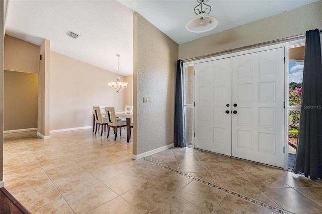 13167 Roseanna Dr, Spring Hill, FL 34609 - tiled entryway with a chandelier and baseboards