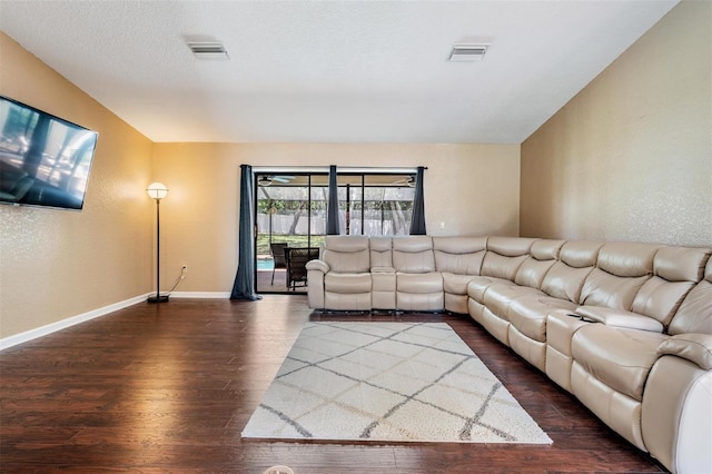 13167 Roseanna Dr, Spring Hill, FL 34609 - living room featuring dark wood finished floors and a textured wall