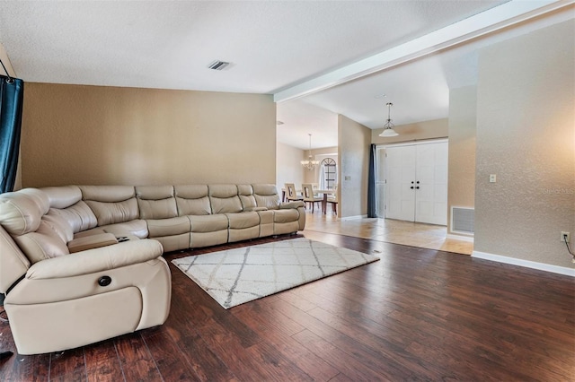 13167 Roseanna Dr, Spring Hill, FL 34609 - living area featuring wood finished floors, a textured wall, and a chandelier