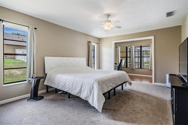13167 Roseanna Dr, Spring Hill, FL 34609 - bedroom with a textured wall, carpet floors, a textured ceiling, and ceiling fan