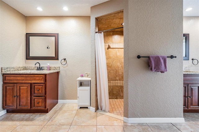13167 Roseanna Dr, Spring Hill, FL 34609 - bathroom with vanity, tiled shower, tile patterned floors, a textured wall, and recessed lighting