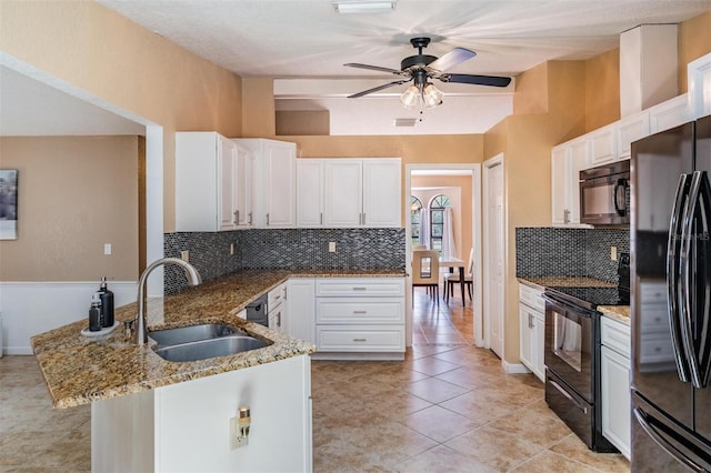 13167 Roseanna Dr, Spring Hill, FL 34609 - kitchen with black appliances, a peninsula, backsplash, light stone countertops, and a ceiling fan