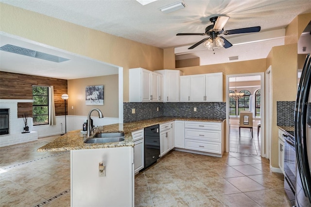 13167 Roseanna Dr, Spring Hill, FL 34609 - kitchen with dishwasher, a peninsula, light stone countertops, white cabinets, and decorative backsplash
