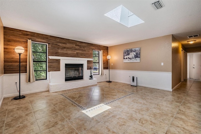 13167 Roseanna Dr, Spring Hill, FL 34609 - unfurnished living room with a skylight, a fireplace, and tile patterned flooring