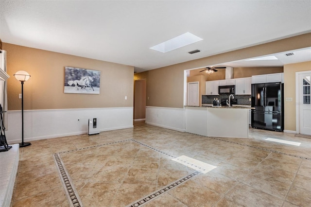 13167 Roseanna Dr, Spring Hill, FL 34609 - unfurnished living room with a skylight and light tile patterned floors