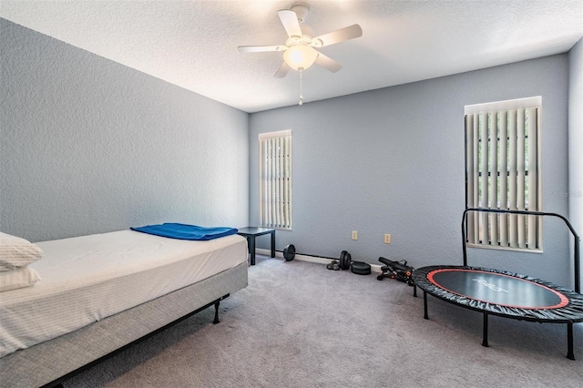 13167 Roseanna Dr, Spring Hill, FL 34609 - carpeted bedroom with a textured wall, ceiling fan, and a textured ceiling