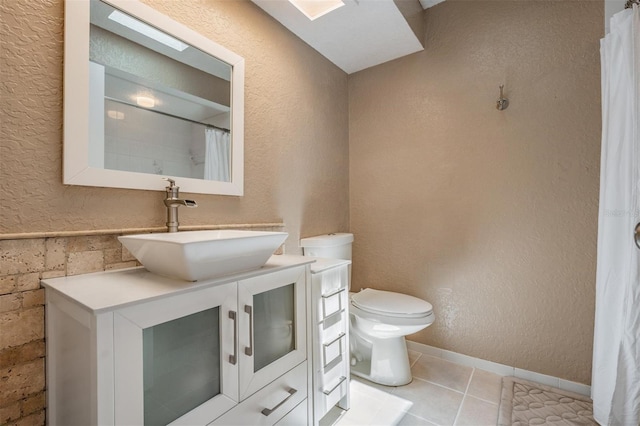 13167 Roseanna Dr, Spring Hill, FL 34609 - full bathroom featuring vanity, tile patterned floors, a textured wall, and a shower with curtain