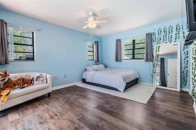 13167 Roseanna Dr, Spring Hill, FL 34609 - bedroom with wood finished floors, multiple windows, and ceiling fan