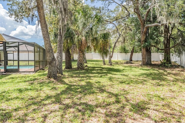 13167 Roseanna Dr, Spring Hill, FL 34609 - fenced backyard with a lanai