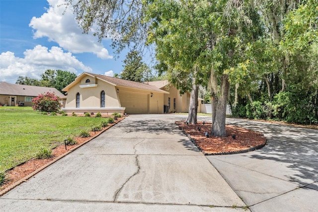 13167 Roseanna Dr, Spring Hill, FL 34609 - view of front facade featuring stucco siding, driveway, a front lawn, and a garage