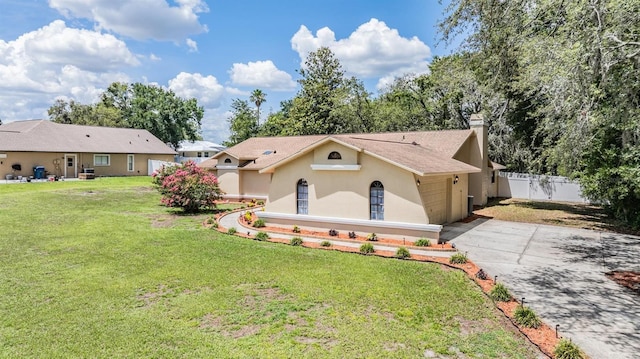 13167 Roseanna Dr, Spring Hill, FL 34609 - view of front facade with stucco siding, concrete driveway, a chimney, and an attached garage