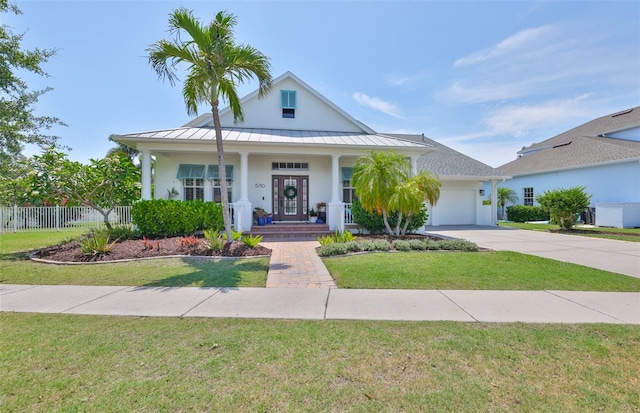 5710 Tortoise Pl, Apollo Beach, FL 33572 - view of front of home with a standing seam roof, an attached garage, driveway, and stucco siding