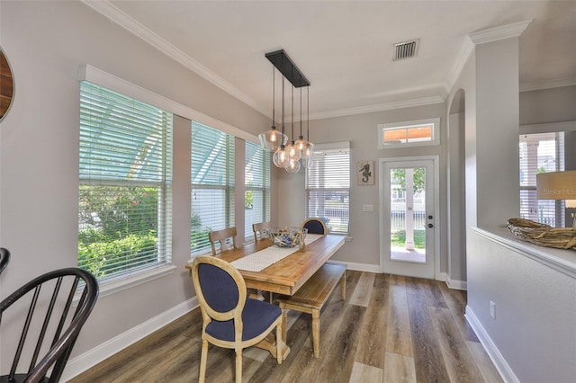 5710 Tortoise Pl, Apollo Beach, FL 33572 - dining space with wood finished floors, ornamental molding, and a chandelier