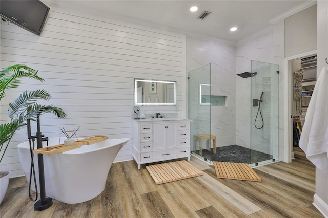 5710 Tortoise Pl, Apollo Beach, FL 33572 - full bath with crown molding, a marble finish shower, vanity, wood finished floors, and a soaking tub