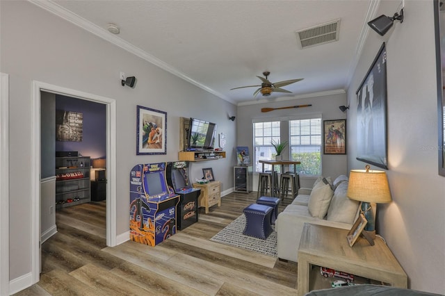 5710 Tortoise Pl, Apollo Beach, FL 33572 - living room with ceiling fan, wood finished floors, and crown molding