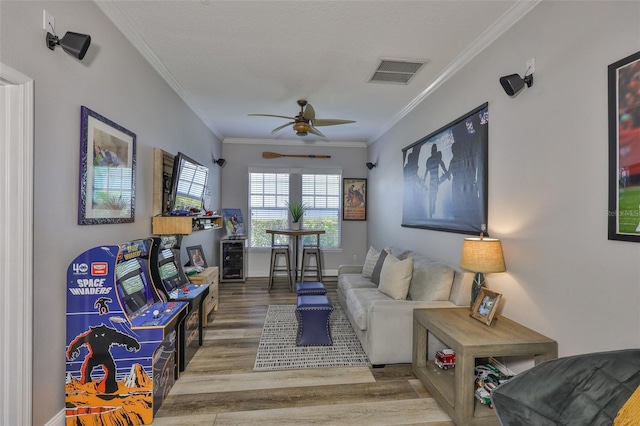 5710 Tortoise Pl, Apollo Beach, FL 33572 - living room featuring wood finished floors, a ceiling fan, crown molding, and beverage cooler
