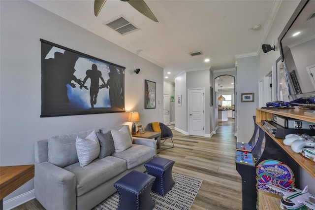 5710 Tortoise Pl, Apollo Beach, FL 33572 - living area with ornamental molding, a ceiling fan, wood finished floors, arched walkways, and recessed lighting
