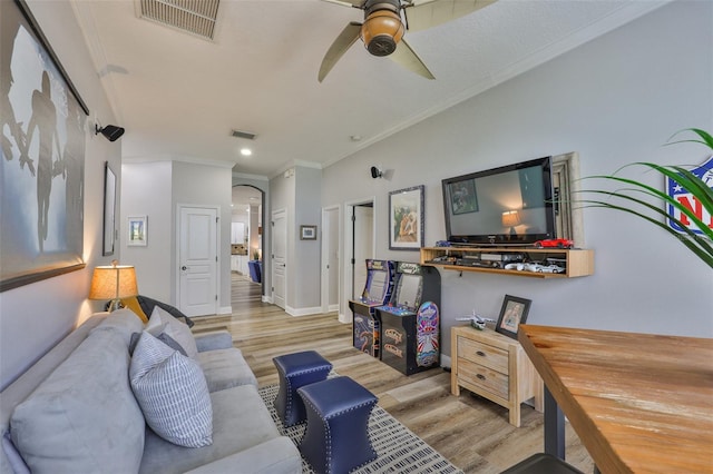 5710 Tortoise Pl, Apollo Beach, FL 33572 - living room featuring wood finished floors, arched walkways, ornamental molding, ceiling fan, and recessed lighting