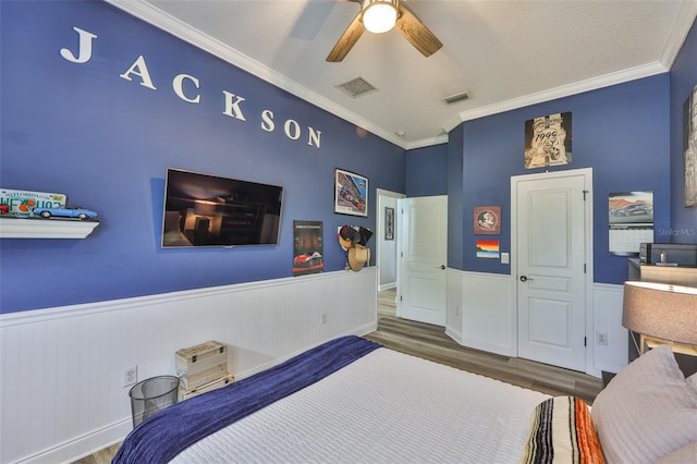 5710 Tortoise Pl, Apollo Beach, FL 33572 - bedroom featuring wood finished floors, wainscoting, ornamental molding, and ceiling fan