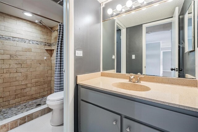 2901 W 26th St Unit 301, Bradenton, FL 34205 - bathroom featuring vanity, a tile shower, and tile patterned flooring