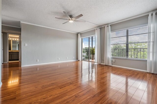 2901 W 26th St Unit 301, Bradenton, FL 34205 - unfurnished room with a ceiling fan, a textured ceiling, wood finished floors, and crown molding