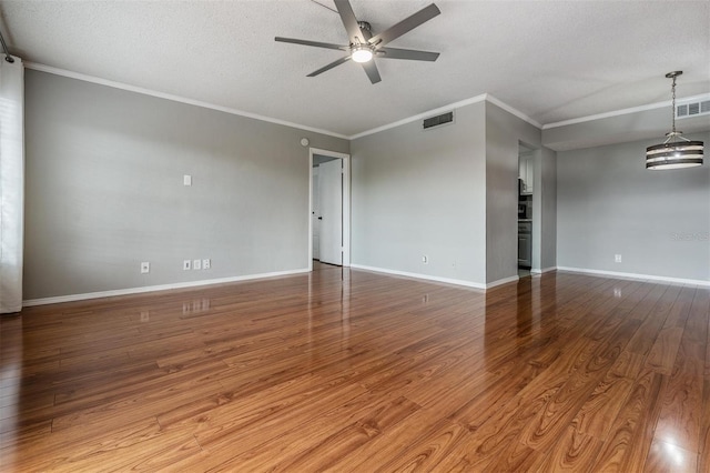 2901 W 26th St Unit 301, Bradenton, FL 34205 - spare room featuring ceiling fan, wood finished floors, ornamental molding, and a textured ceiling