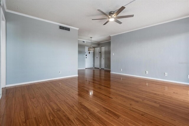 2901 W 26th St Unit 301, Bradenton, FL 34205 - empty room with a ceiling fan, ornamental molding, wood finished floors, and a textured ceiling