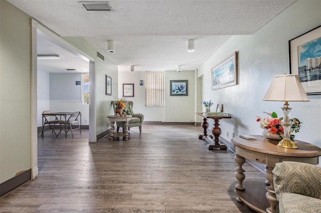 2901 W 26th St Unit 301, Bradenton, FL 34205 - sitting room with a textured ceiling and wood finished floors