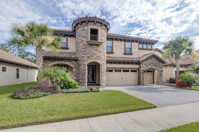 21675 Amelia Rose Way, Land O Lakes, FL 34637 - mediterranean / spanish home with stucco siding, an attached garage, decorative driveway, a tile roof, and stone siding