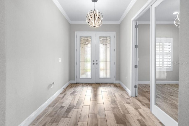 21675 Amelia Rose Way, Land O Lakes, FL 34637 - entrance foyer with a chandelier, french doors, light wood-style flooring, and crown molding