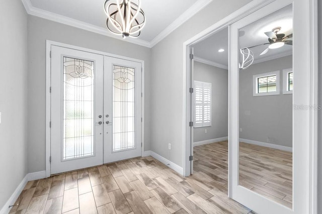 21675 Amelia Rose Way, Land O Lakes, FL 34637 - foyer entrance featuring french doors, light wood-style floors, crown molding, a chandelier, and a ceiling fan