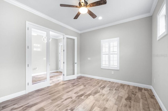 21675 Amelia Rose Way, Land O Lakes, FL 34637 - unfurnished bedroom with multiple windows, light wood finished floors, ornamental molding, french doors, and recessed lighting