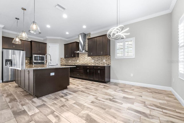 21675 Amelia Rose Way, Land O Lakes, FL 34637 - kitchen with appliances with stainless steel finishes, wall chimney exhaust hood, backsplash, dark brown cabinetry, and ornamental molding