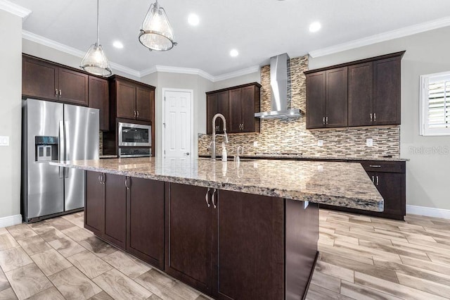 21675 Amelia Rose Way, Land O Lakes, FL 34637 - kitchen featuring stainless steel appliances, wall chimney range hood, dark brown cabinetry, tasteful backsplash, and crown molding