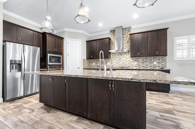 21675 Amelia Rose Way, Land O Lakes, FL 34637 - kitchen with appliances with stainless steel finishes, wall chimney range hood, tasteful backsplash, dark brown cabinetry, and crown molding